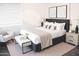 A modern bedroom featuring a stylish bed, complementary furniture, and a window with natural light at 9967 W Devonshire Ave, Phoenix, AZ 85037