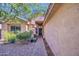 Inviting front entryway featuring a brick path, lush landscaping, and a decorative glass front door at 9967 W Devonshire Ave, Phoenix, AZ 85037