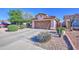 Charming single-story home featuring a two-car garage, desert landscaping, and a well-maintained front yard at 9967 W Devonshire Ave, Phoenix, AZ 85037