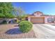 Single-story house featuring desert landscaping, a two-car garage, and mature trees for added curb appeal at 9967 W Devonshire Ave, Phoenix, AZ 85037