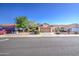 Charming single-story home with a two-car garage, desert landscaping, and mature trees on a sunny day at 9967 W Devonshire Ave, Phoenix, AZ 85037