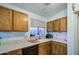 Clean well-lit kitchen with wood cabinets, white counter tops and plenty of natural light at 9967 W Devonshire Ave, Phoenix, AZ 85037