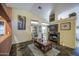 Bright living room showcasing a fireplace, decorative art, a large window, and stylish tile flooring at 9967 W Devonshire Ave, Phoenix, AZ 85037