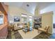 Bright living room with high ceilings, fireplace, and large windows offering natural light at 9967 W Devonshire Ave, Phoenix, AZ 85037