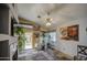 Cozy living room with a fireplace, slate tile floors, bright natural light, and views to the backyard at 9967 W Devonshire Ave, Phoenix, AZ 85037