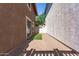 Paver patio between homes leads to backyard with artificial turf and convenient gated access at 999 S Sabino Dr, Gilbert, AZ 85296