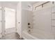 This clean and bright bathroom features a tub and shower combo with tiled walls and a built-in shelf at 999 S Sabino Dr, Gilbert, AZ 85296