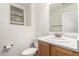 Half bathroom featuring a sink, toilet, and a window for natural light at 999 S Sabino Dr, Gilbert, AZ 85296