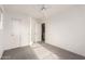 A bright bedroom features neutral walls, carpet, a ceiling fan, and doors to the closet and hallway at 999 S Sabino Dr, Gilbert, AZ 85296