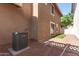 Back exterior of home, features include easy maintenance landscaping and a Goodman HVAC unit at 999 S Sabino Dr, Gilbert, AZ 85296