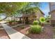 Two-story home with a covered porch and tidy landscaping, and a mature tree in the yard at 999 S Sabino Dr, Gilbert, AZ 85296