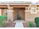 Inviting front porch with decorative columns and neatly trimmed shrubs at 999 S Sabino Dr, Gilbert, AZ 85296
