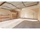 Spacious garage boasts ample storage with overhead racks, shelving, and bright lighting at 999 S Sabino Dr, Gilbert, AZ 85296