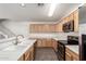 Bright kitchen with stainless steel appliances, light wood cabinets, and neutral countertops at 999 S Sabino Dr, Gilbert, AZ 85296
