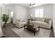 Bright living room featuring neutral tones, large windows and ceiling fan at 999 S Sabino Dr, Gilbert, AZ 85296