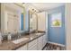 Bright blue bathroom featuring a double sink vanity, granite countertops, and modern fixtures and stylish decor at 1014 S Porter St, Gilbert, AZ 85296