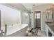 Bright bathroom featuring a soaking tub, glass shower, granite counters, and double sinks at 1014 S Porter St, Gilbert, AZ 85296