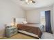 Neutral bedroom featuring a ceiling fan, a comfy bed, and a bedside table with lamp for a cozy atmosphere at 1014 S Porter St, Gilbert, AZ 85296