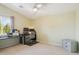 Spacious bedroom with a dedicated workspace, featuring dual monitors and a rolling chair, and side table at 1014 S Porter St, Gilbert, AZ 85296