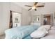 Comfortable main bedroom featuring a ceiling fan, ensuite bathroom, and plenty of light at 1014 S Porter St, Gilbert, AZ 85296