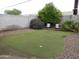 Backyard putting green with mature trees and foliage creating a relaxing outdoor space at 10201 S 49Th St, Phoenix, AZ 85044