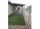 Enclosed backyard with artificial grass, a small dog run, and a view of the sparkling pool at 10201 S 49Th St, Phoenix, AZ 85044