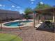 Inviting backyard features a fenced in pool with lounge area, covered patio, and low-maintenance gravel at 10201 S 49Th St, Phoenix, AZ 85044