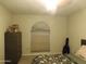 Bedroom featuring a blind-covered window and a dresser, illuminated by an overhead light at 10201 S 49Th St, Phoenix, AZ 85044