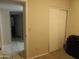 View of carpeted bedroom with a closet, access to other rooms, and neutral walls at 10201 S 49Th St, Phoenix, AZ 85044