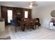 Dining room featuring a wood table, chairs, and views of the brick fireplace and bright windows at 10201 S 49Th St, Phoenix, AZ 85044