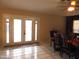 Bright dining area features glass doors, a ceiling fan, and comfortable seating near the kitchen at 10201 S 49Th St, Phoenix, AZ 85044