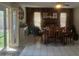 Bright dining room features wood paneling, tile flooring, a ceiling fan, and sliding glass door to outside at 10201 S 49Th St, Phoenix, AZ 85044