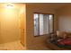 Inviting entryway featuring a wood front door, window with blinds, and a cozy daybed at 10201 S 49Th St, Phoenix, AZ 85044