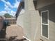Exterior shot shows the side of the house with a chimney, small window, and access to the backyard at 10201 S 49Th St, Phoenix, AZ 85044