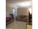 Comfortable living room with tile flooring and neutral-toned sofas, perfect for relaxation at 10201 S 49Th St, Phoenix, AZ 85044