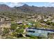 Elevated view showcases community amenities, pools, tennis courts, and desert landscape, providing an active lifestyle at 10239 E Salt Bush Dr, Scottsdale, AZ 85255