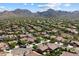 Picturesque aerial view of a residential neighborhood surrounded by scenic mountains, offering a serene setting at 10239 E Salt Bush Dr, Scottsdale, AZ 85255