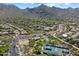 Stunning aerial shot of a community featuring amenities like a pool and tennis courts amid natural desert landscape at 10239 E Salt Bush Dr, Scottsdale, AZ 85255