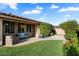 Outdoor patio area featuring well-manicured artificial turf, patio furniture, and views of a lush backyard at 10239 E Salt Bush Dr, Scottsdale, AZ 85255