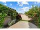 Beautiful backyard featuring an artificial lawn, mature trees, flowering plants, and a patio area at 10239 E Salt Bush Dr, Scottsdale, AZ 85255