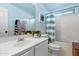 Bright bathroom with a clean white vanity, fresh plant, and shower-tub combination at 10239 E Salt Bush Dr, Scottsdale, AZ 85255