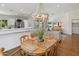 Bright dining room features wood floors, a round table with seating, and an open floor plan at 10239 E Salt Bush Dr, Scottsdale, AZ 85255