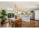 Dining room featuring a light fixture, hardwood floors, and views to the kitchen at 10239 E Salt Bush Dr, Scottsdale, AZ 85255