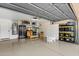 Spacious garage with epoxy flooring, storage cabinets, shelving, and room for multiple vehicles at 10239 E Salt Bush Dr, Scottsdale, AZ 85255