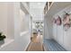 Bright hallway with white walls, hardwood floors, and built-in storage; leads into the living area at 10239 E Salt Bush Dr, Scottsdale, AZ 85255