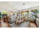 Bright living room featuring hardwood floors, recessed lighting, and large windows overlooking the backyard at 10239 E Salt Bush Dr, Scottsdale, AZ 85255