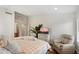 Bright bedroom featuring a TV, cozy chair, and large windows offering a relaxing retreat at 10239 E Salt Bush Dr, Scottsdale, AZ 85255
