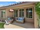 Covered patio features comfortable seating with pillows, offering a cozy outdoor living space at 10239 E Salt Bush Dr, Scottsdale, AZ 85255