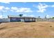 Spacious backyard showcasing a gray single story house, block wall, and ample space for outdoor activities and landscaping at 1027 S Lola Ln, Tempe, AZ 85281