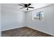 This spacious bedroom features wood floors, a ceiling fan, and a bright window for natural light at 1027 S Lola Ln, Tempe, AZ 85281